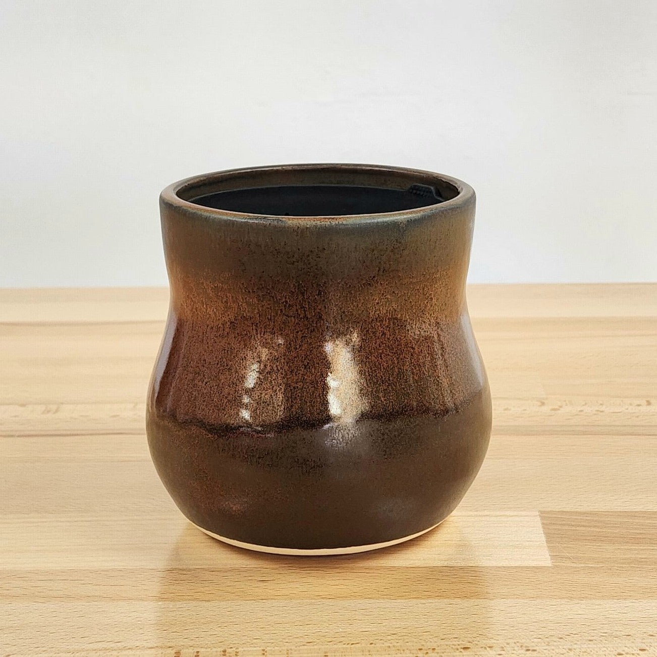 A ceramic Happy Roots Plant Pot in the &